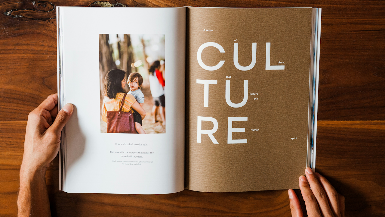 Open book held by hands: left page shows woman holding child with quote; right page spells "CULTURE" creatively.