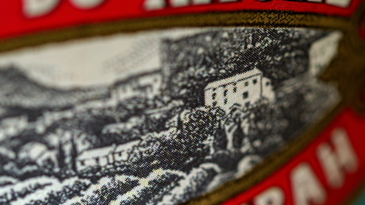 A close-up of a wine label featuring text, set against a winter-themed background.